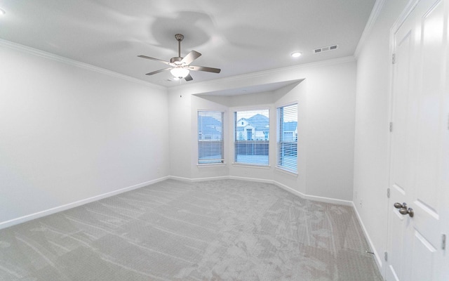 empty room with light colored carpet, ceiling fan, and crown molding