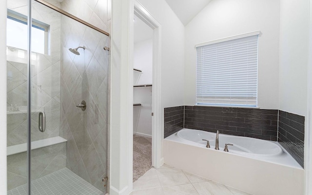 bathroom with tile patterned flooring, plus walk in shower, and vaulted ceiling