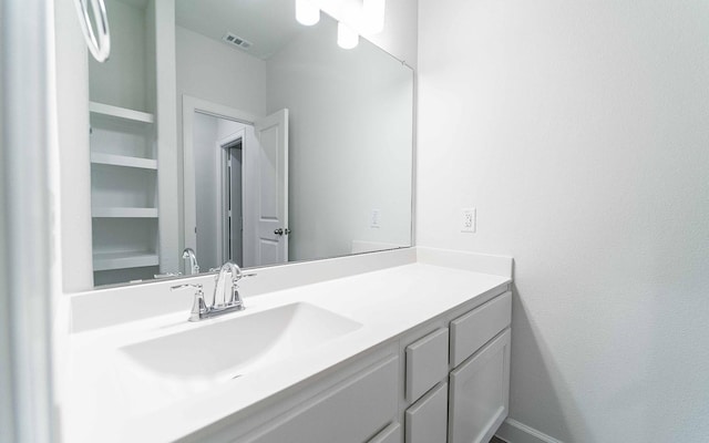 bathroom featuring built in features and vanity