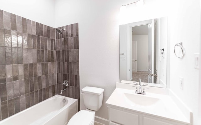 full bathroom with toilet, vanity, and tiled shower / bath