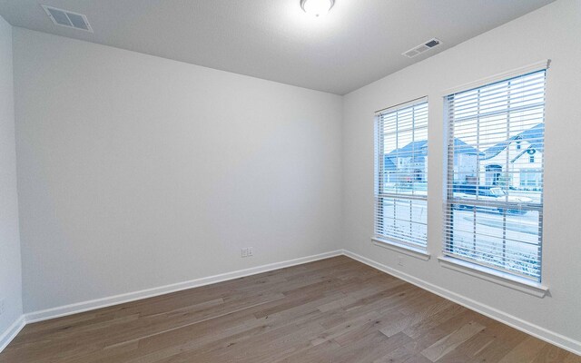 unfurnished room with wood-type flooring