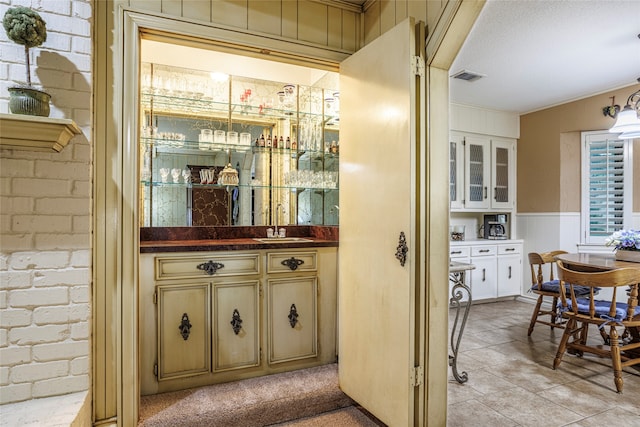 bar featuring ornamental molding and sink