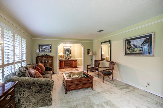 living room with crown molding and light carpet