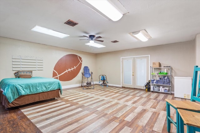 bedroom featuring ceiling fan, refrigerator, and light wood-type flooring