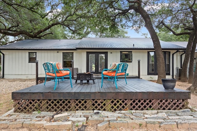 back of house featuring french doors and a wooden deck