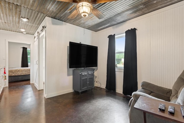 living room featuring wood ceiling, ceiling fan, and a barn door