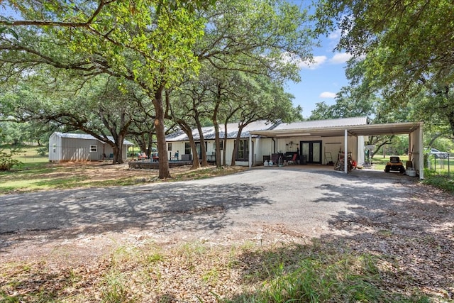 single story home with a storage shed and a carport