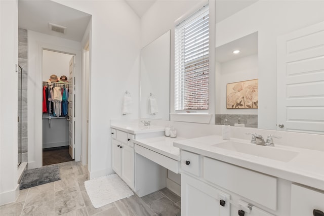 bathroom with a wealth of natural light, vanity, and an enclosed shower