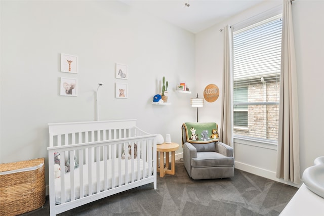 bedroom featuring carpet and a crib