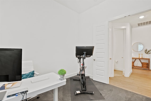 workout area with hardwood / wood-style flooring