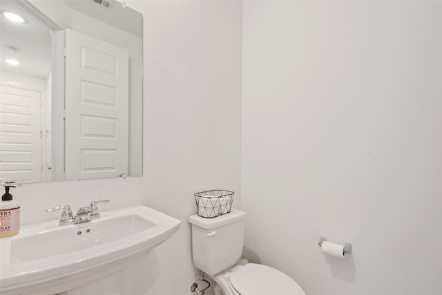 bathroom featuring toilet and sink