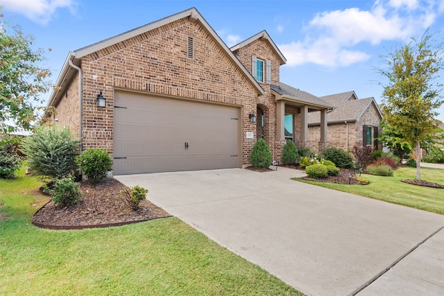 view of front of property with a garage and a front lawn