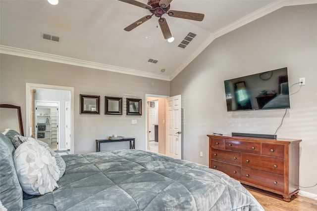 bedroom featuring ceiling fan, light wood-type flooring, lofted ceiling, and ornamental molding