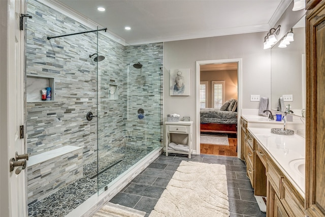 bathroom featuring vanity, an enclosed shower, and ornamental molding