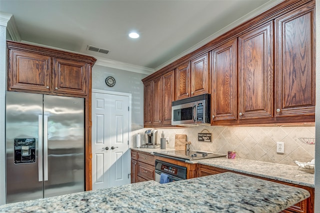 kitchen featuring light stone countertops, crown molding, appliances with stainless steel finishes, and tasteful backsplash