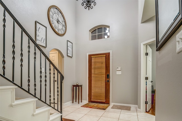 tiled foyer entrance featuring a high ceiling