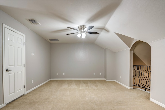 additional living space with ceiling fan, light colored carpet, and lofted ceiling