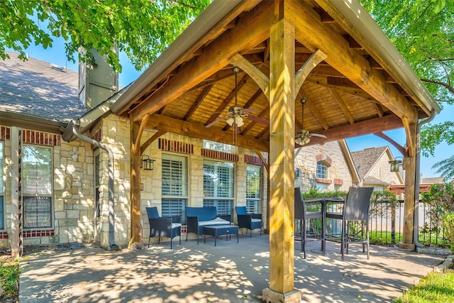 view of patio / terrace with a gazebo, ceiling fan, and an outdoor living space