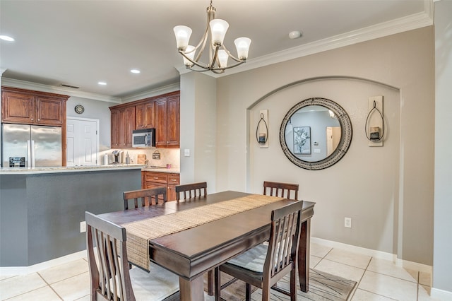 dining room with a chandelier, light tile patterned floors, and ornamental molding