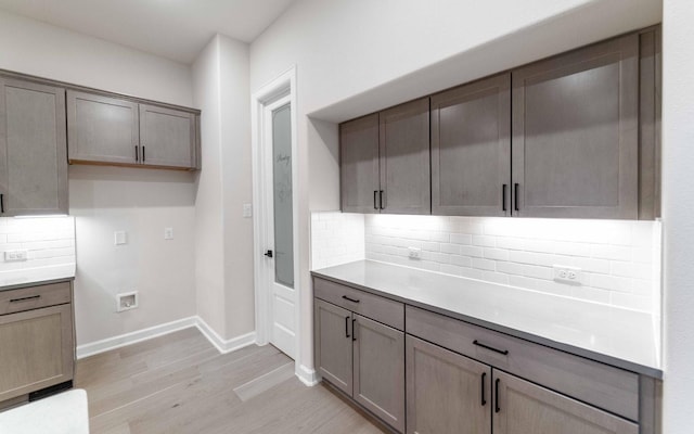 kitchen with decorative backsplash and light hardwood / wood-style flooring