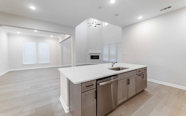 kitchen with dishwasher, an island with sink, sink, ceiling fan, and light hardwood / wood-style floors