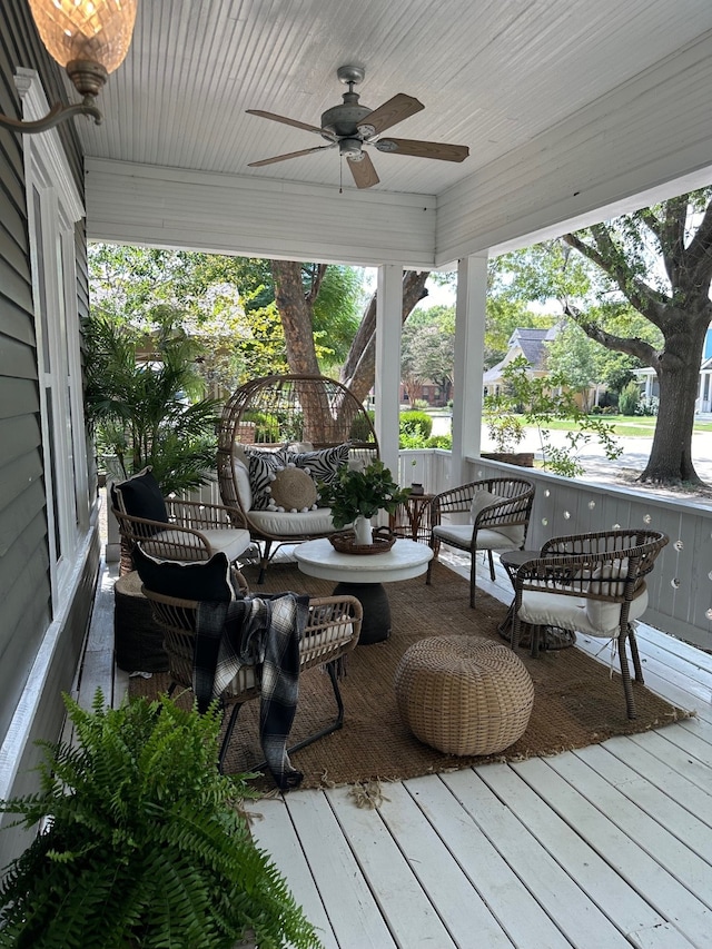 deck featuring ceiling fan and an outdoor hangout area