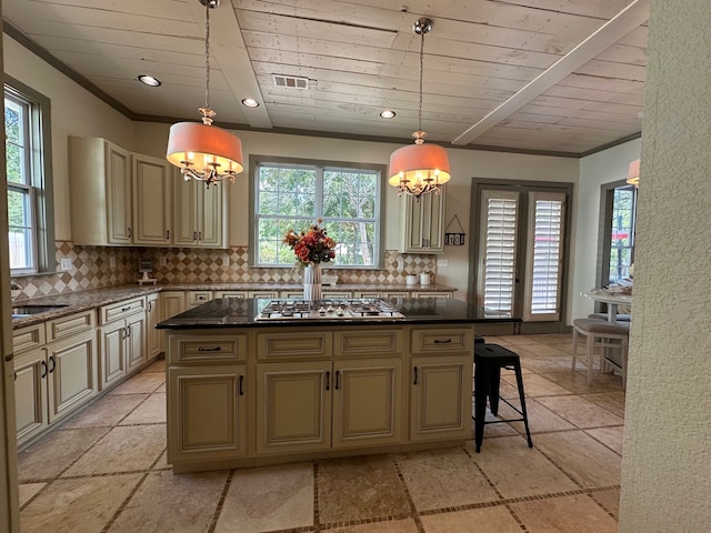 kitchen featuring decorative backsplash, a chandelier, a center island, and decorative light fixtures