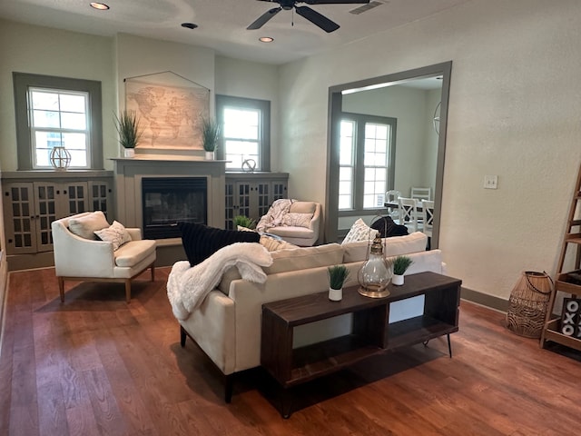 living room with wood-type flooring, ceiling fan, and plenty of natural light