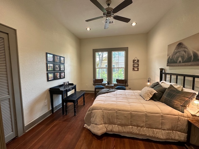 bedroom with dark hardwood / wood-style flooring and ceiling fan