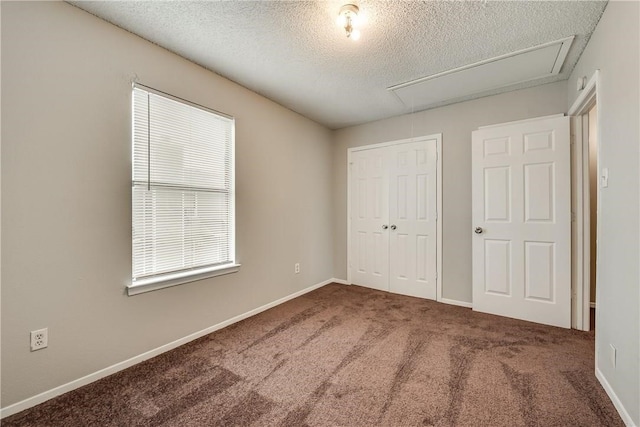 unfurnished bedroom with a textured ceiling, a closet, and carpet floors