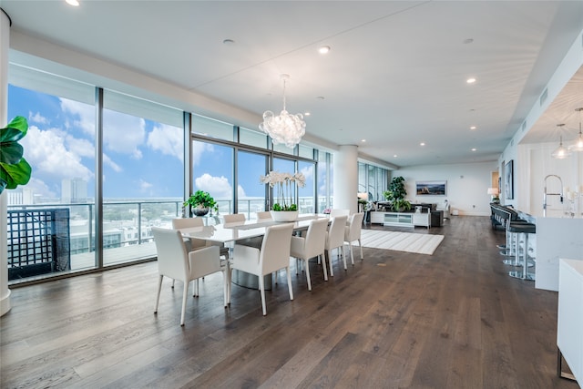 dining room featuring dark wood-type flooring and an inviting chandelier