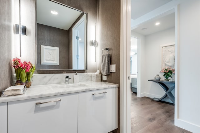 bathroom with vanity and hardwood / wood-style flooring