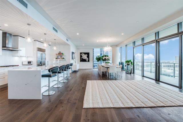 interior space featuring dark wood-type flooring, plenty of natural light, and an inviting chandelier