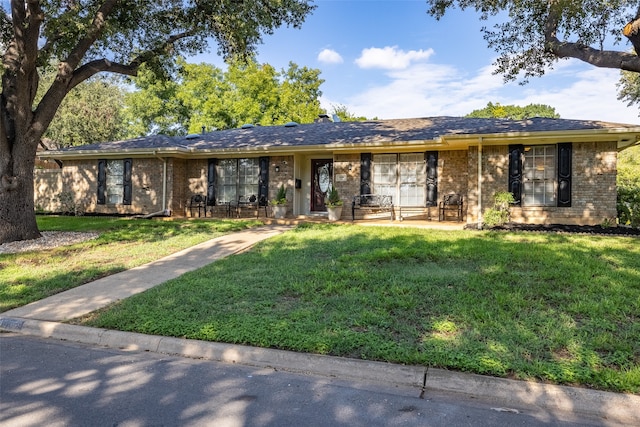 ranch-style home featuring a front yard