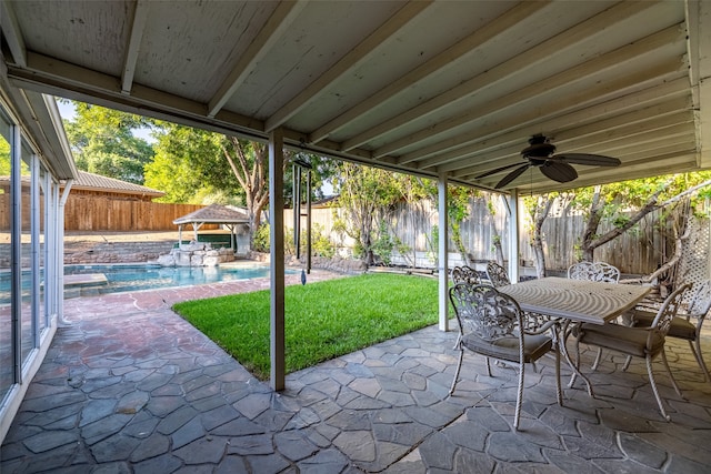 view of patio featuring a fenced in pool and ceiling fan