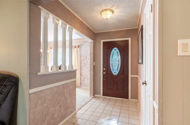 entryway featuring ornamental molding, a textured ceiling, and light tile patterned flooring