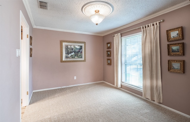 empty room with a textured ceiling, crown molding, and carpet