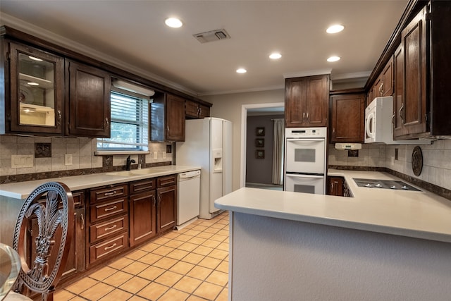 kitchen featuring ornamental molding, sink, white appliances, and dark brown cabinets