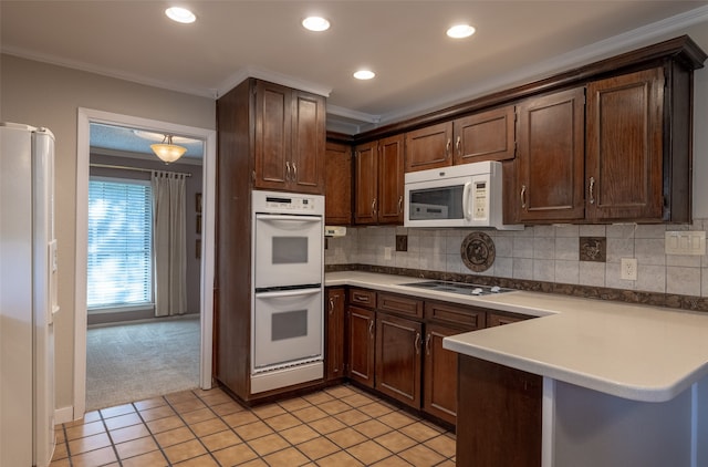 kitchen featuring crown molding, white appliances, dark brown cabinets, kitchen peninsula, and light colored carpet