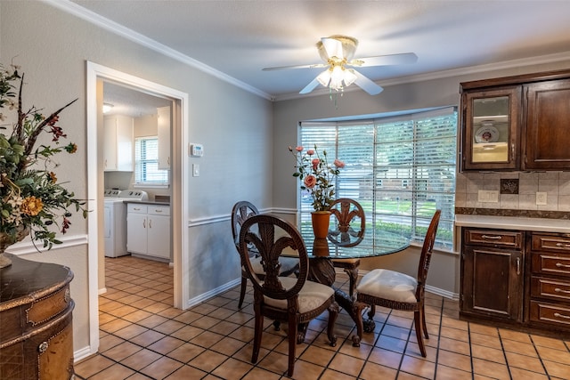 tiled dining space featuring crown molding, ceiling fan, and washer / dryer