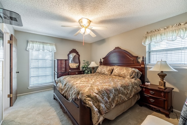 bedroom with a textured ceiling, carpet flooring, and ceiling fan