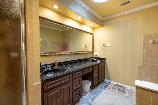 bathroom with crown molding, vanity, tile patterned floors, and walk in shower