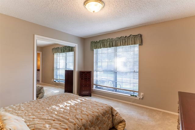 bedroom with a textured ceiling and carpet floors