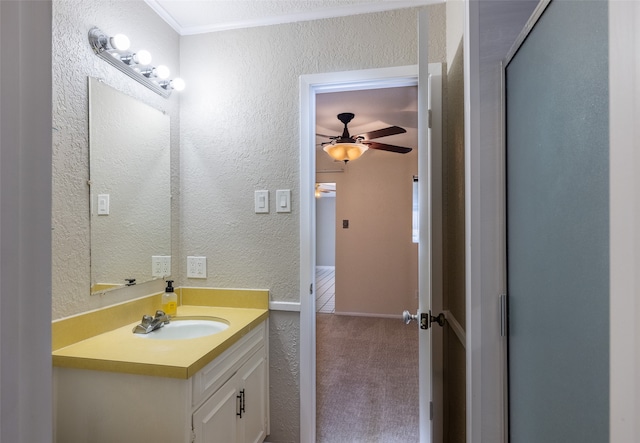 bathroom with ornamental molding, vanity, and ceiling fan