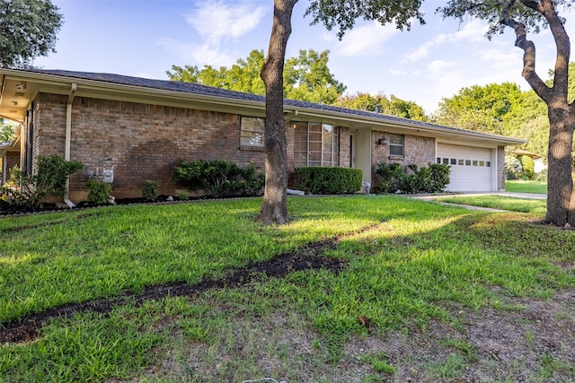 ranch-style house with a garage and a front lawn