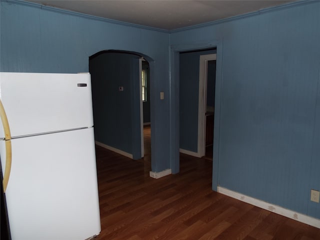 kitchen with ornamental molding, white fridge, and dark hardwood / wood-style floors