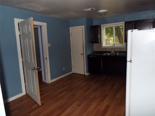 kitchen with dark brown cabinets, dishwasher, dark hardwood / wood-style flooring, sink, and white refrigerator