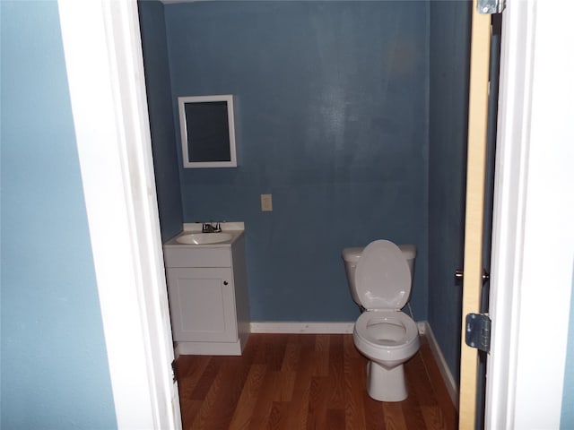 bathroom with vanity, toilet, and wood-type flooring