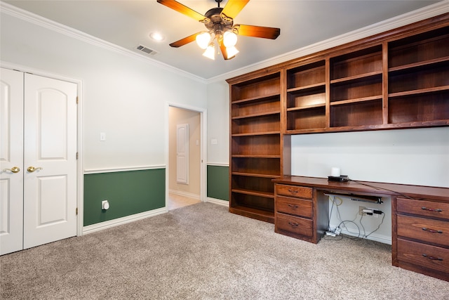 unfurnished office with ceiling fan, light colored carpet, and ornamental molding