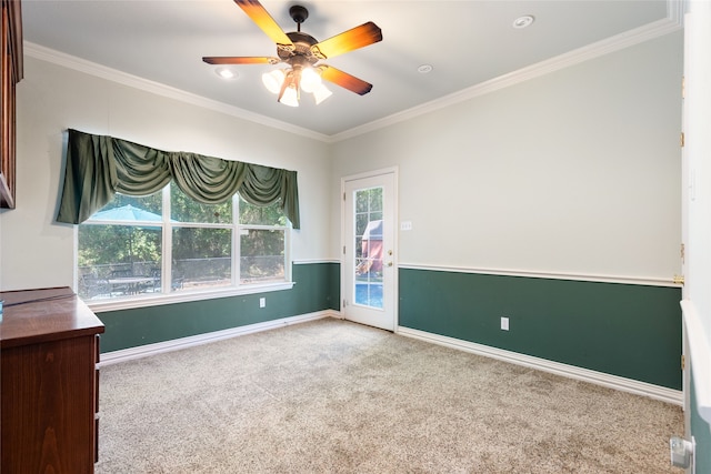 carpeted empty room featuring ceiling fan and ornamental molding